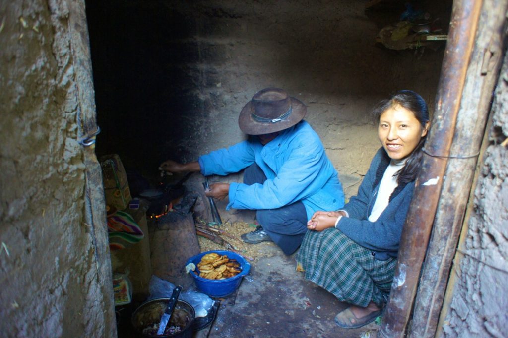 Quechua residents of Amantani Island prepare food over a wood burning stove.
