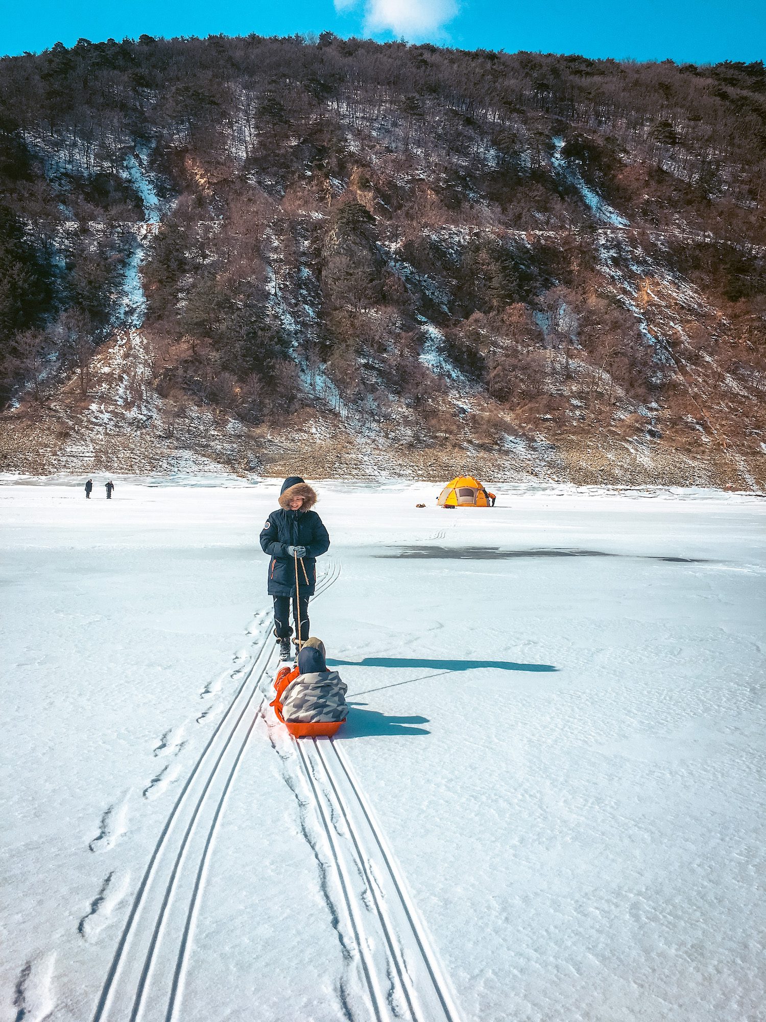 sledding on frozen ice during winter in korea