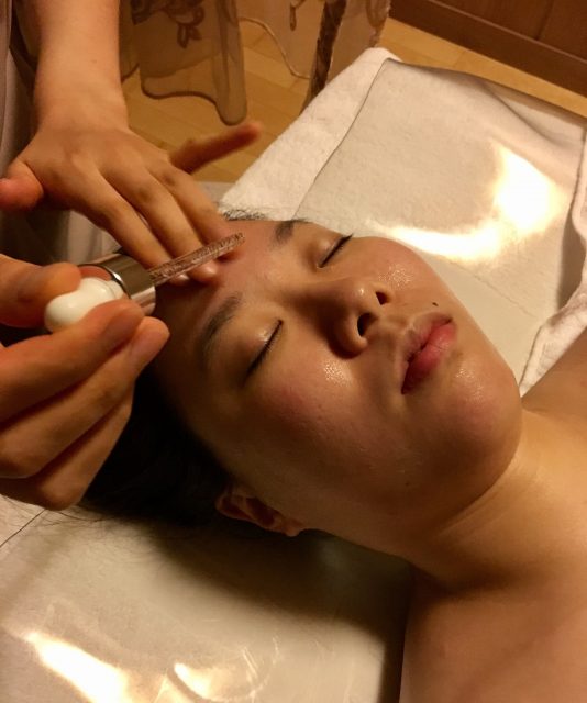 Application of ampoules during a facial in Seoul.