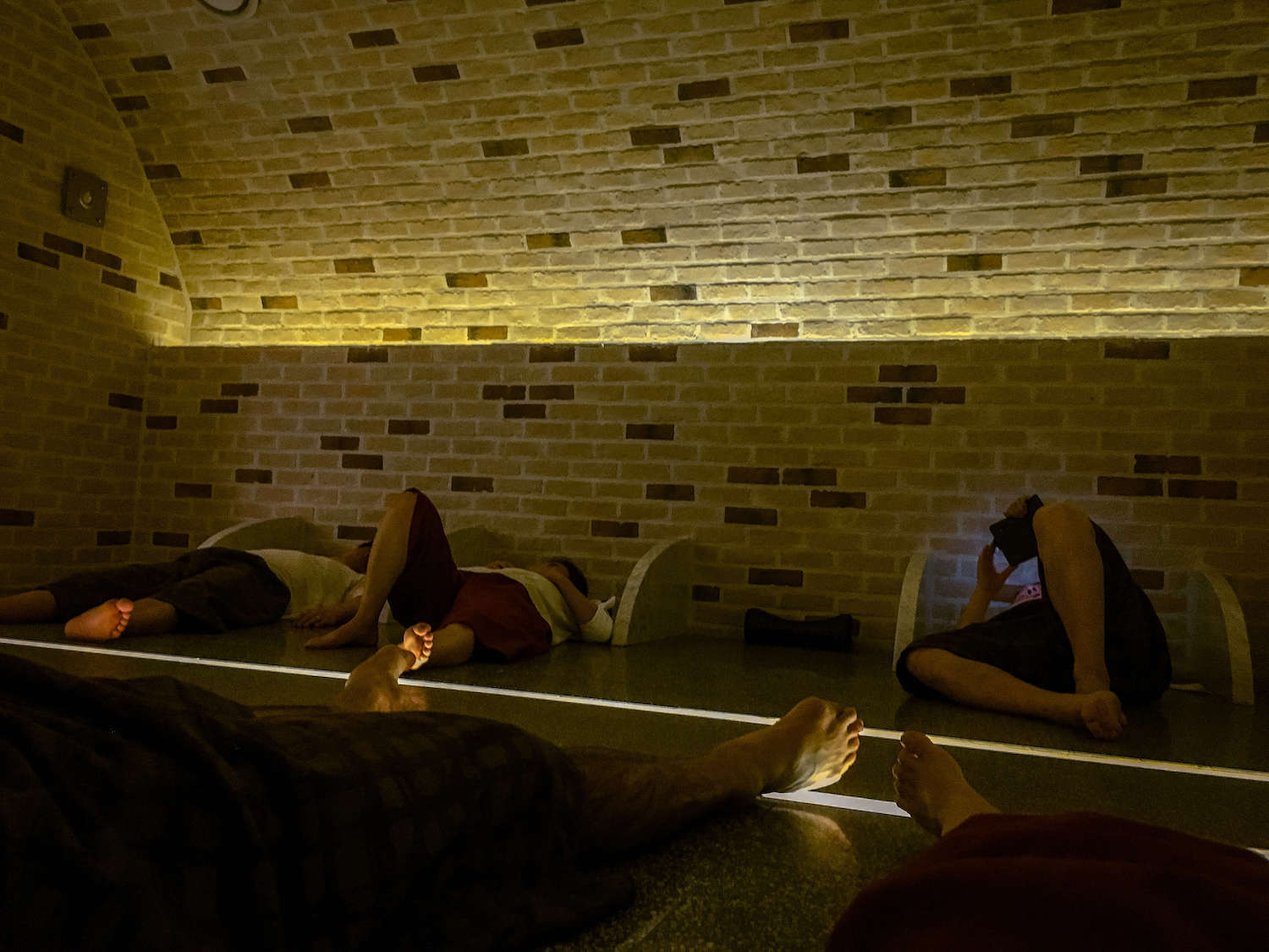 people relaxing in a room at a jjimjilbang