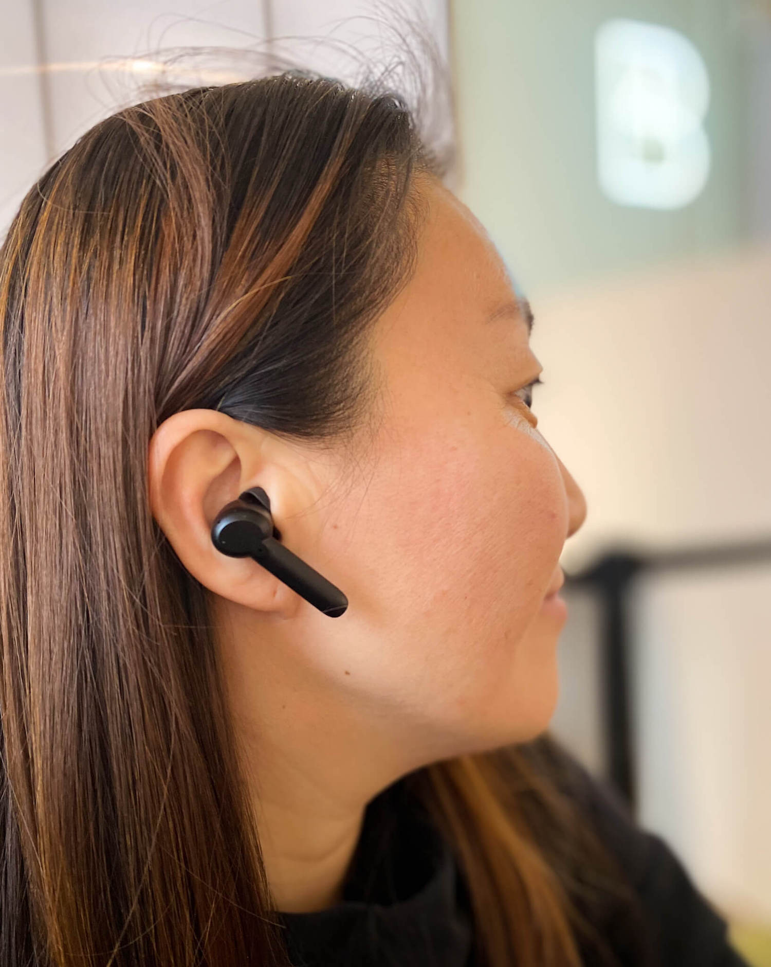 xFyro girl wearing ANC Pro wireless earbuds